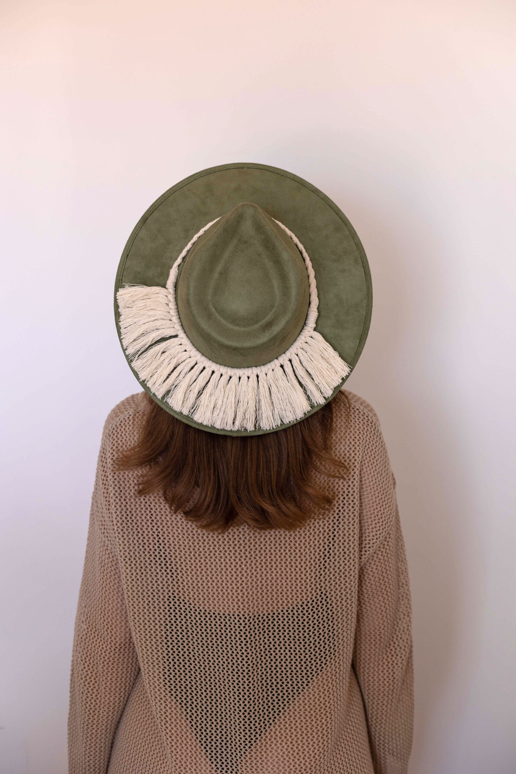 A cream colored hat accessory made in Mexico. Macrame stye “Tulum”